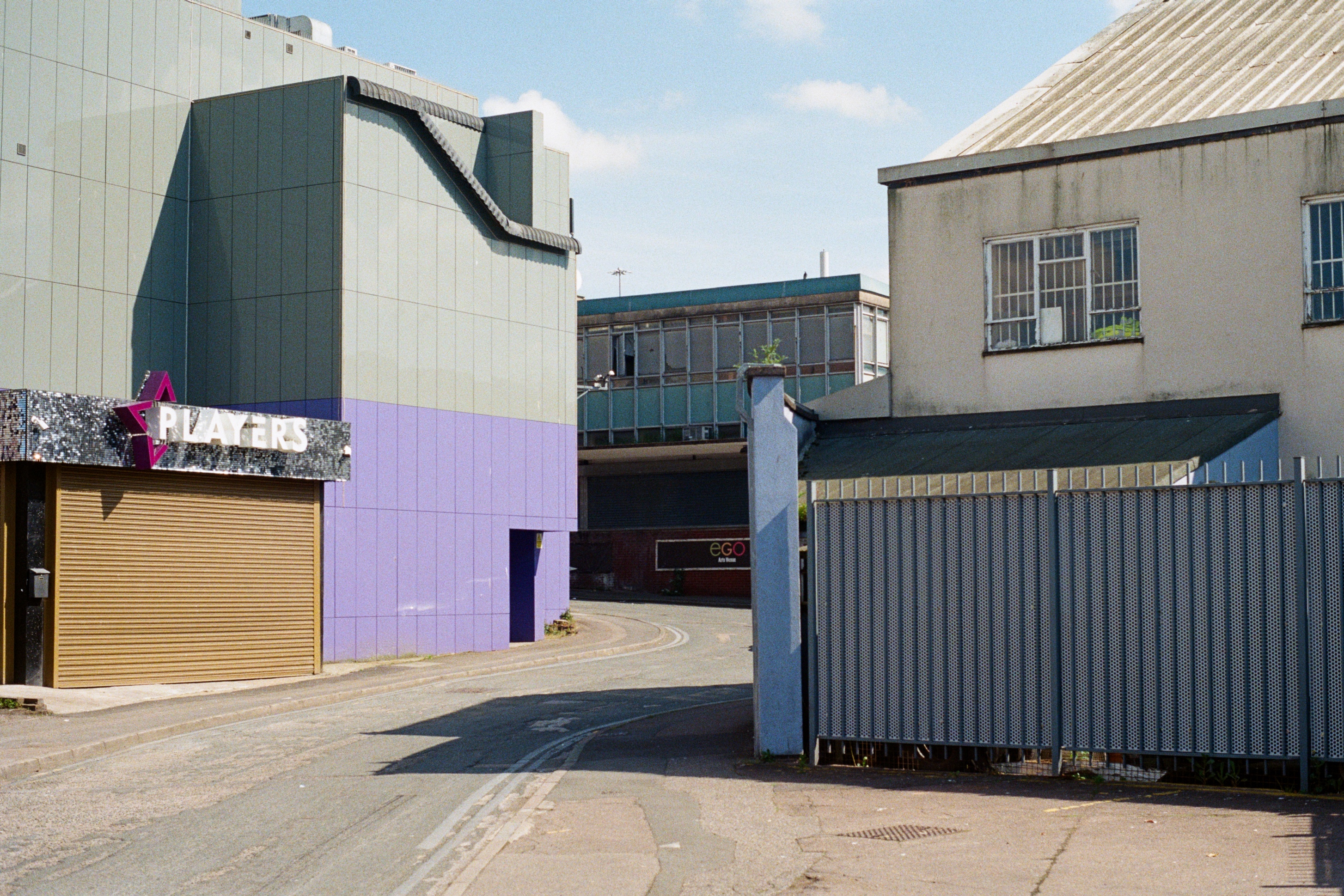 The shuttered entrance to a nightclub in Coventry, with purple and grey panelling.