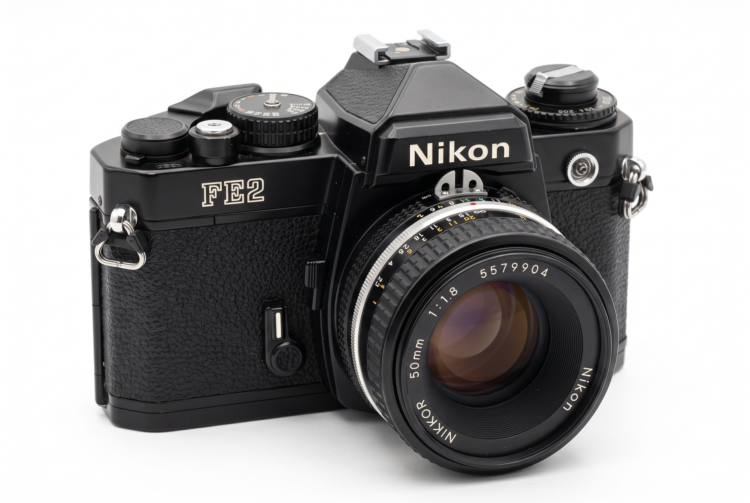 A vintage camera resting on an old wooden table overlooking a foggy morning landscape