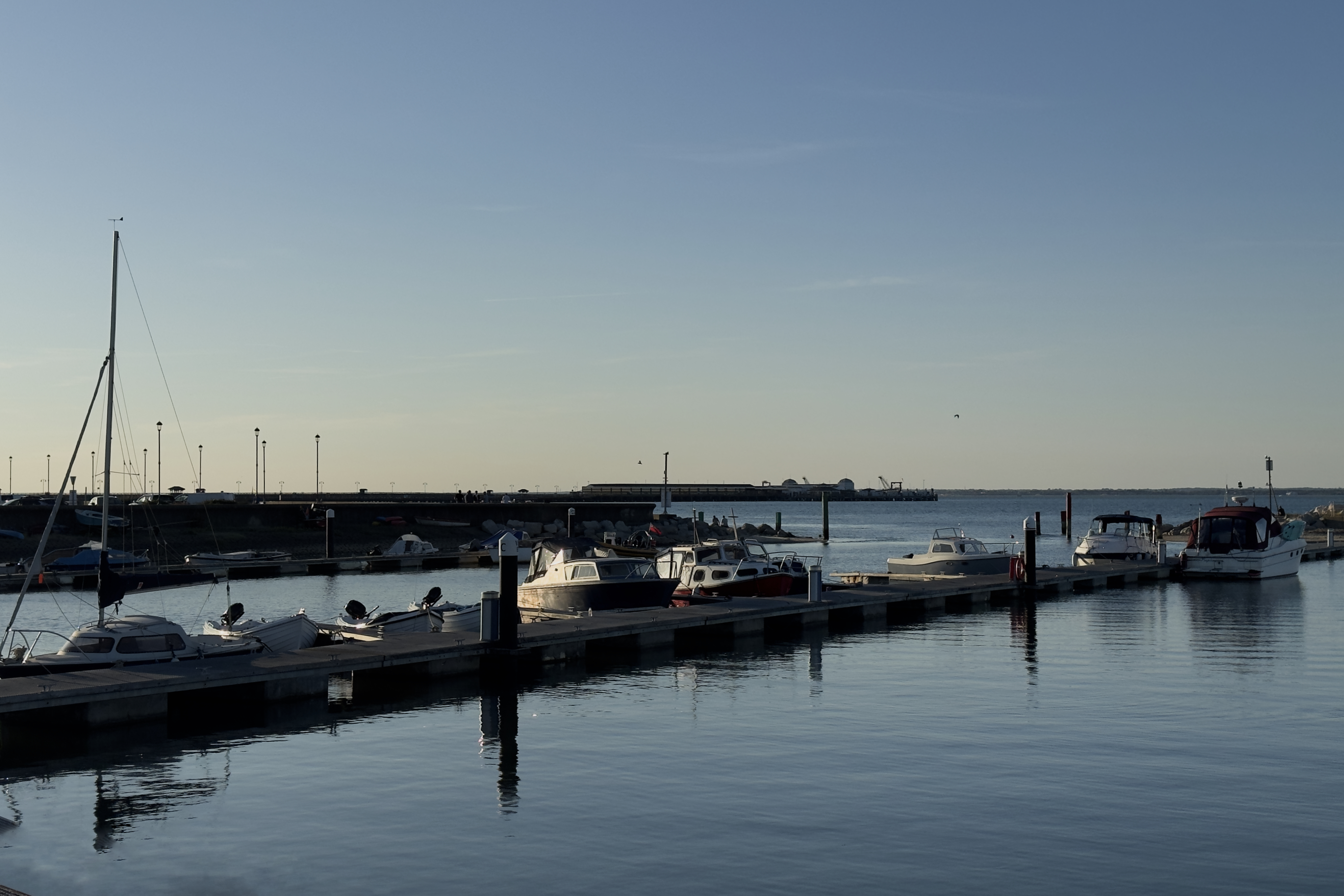 Boats moored in a marina on a calm day